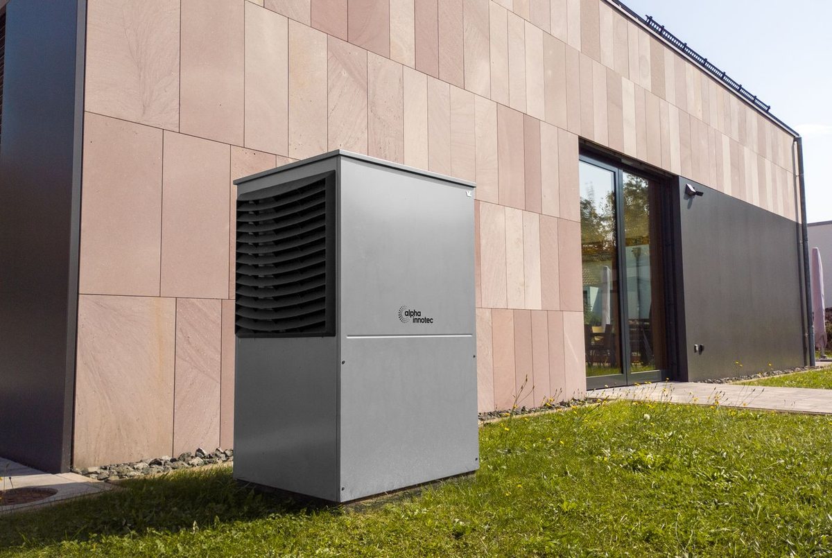 Outdoor heat pump unit beside a house