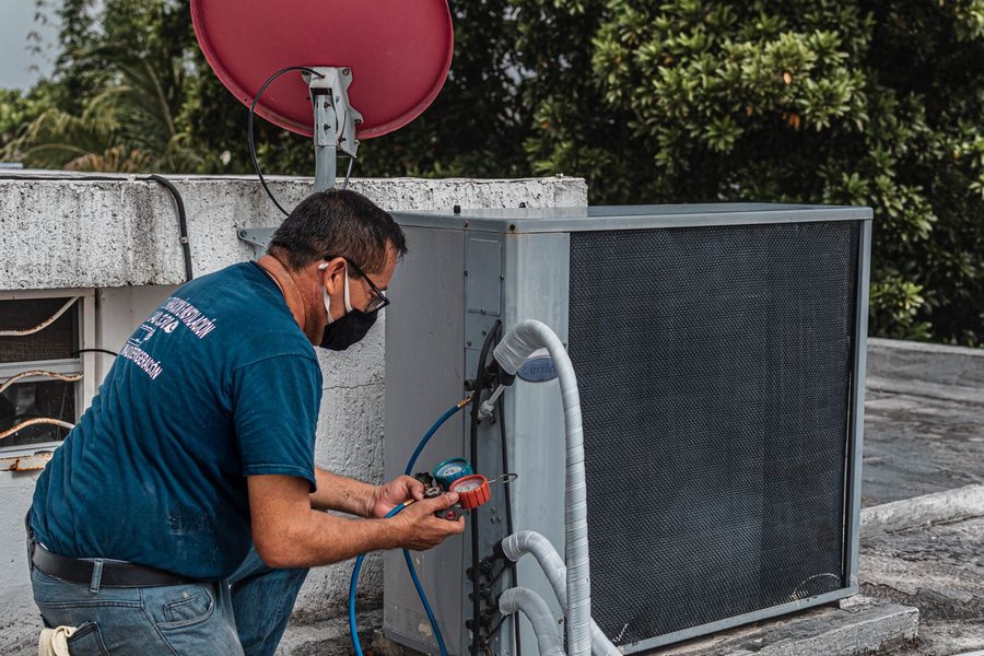 Kenyon & Sons technician servicing a rooftop air-conditioning unit